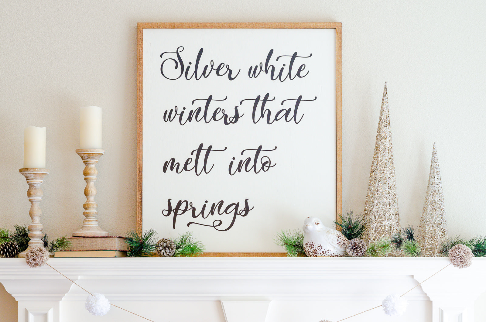 Farmhouse style mantel sign made with Cameo cutting machine. Text on sign reads "Silver white winters that melt into springs"