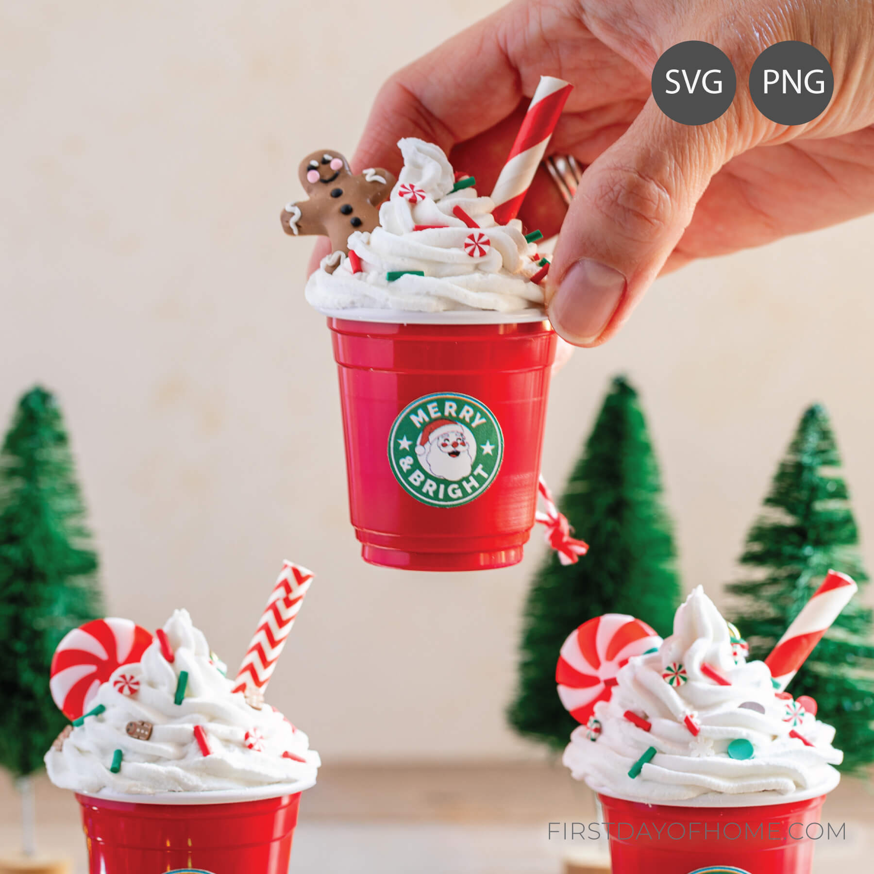 Hand holding a mini coffee cup ornament.