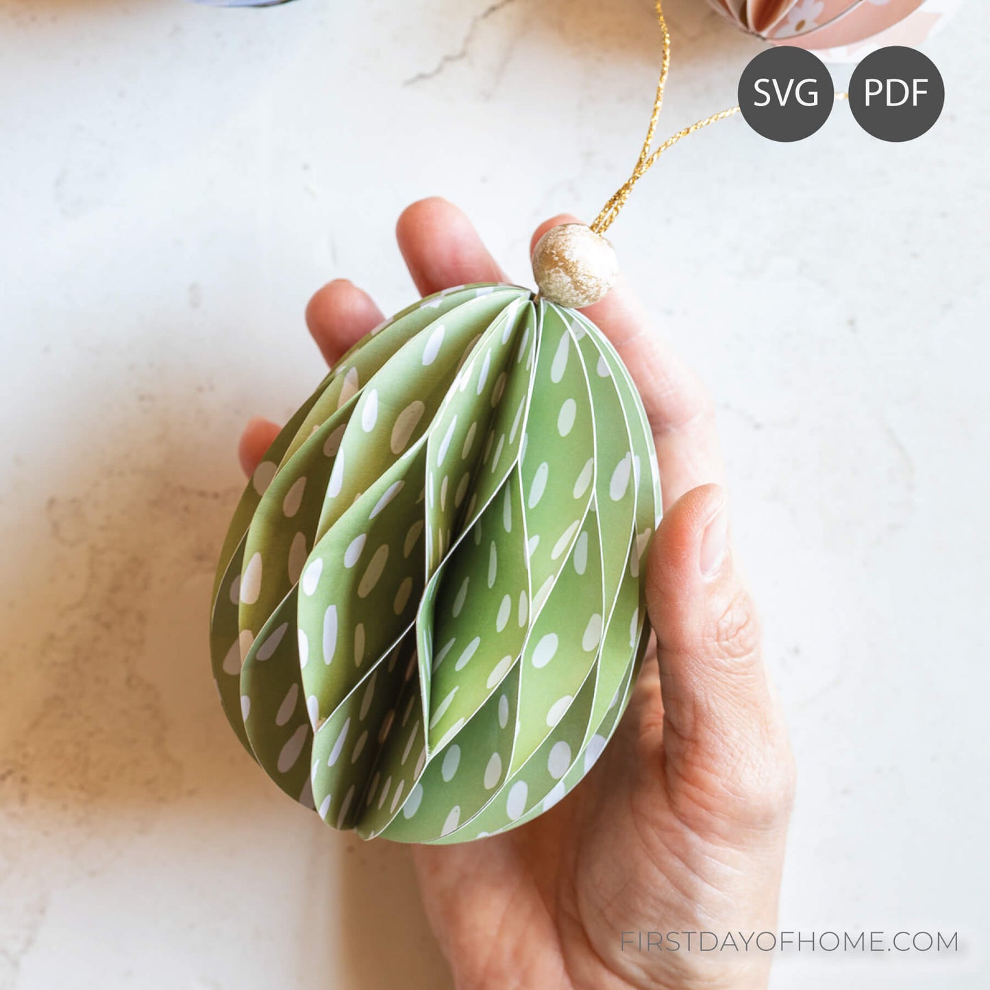 Easter egg paper ornament with a honeycomb pattern, held in a hand.